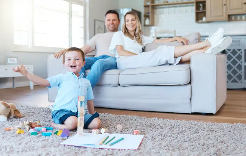 Happy family in clean living room after successful housing disrepair claim