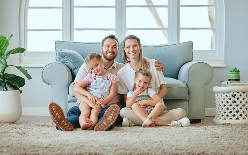 Happy London family in clean, mould-free living room after successful housing disrepair claim